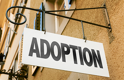 adoption sign hanging in front of business