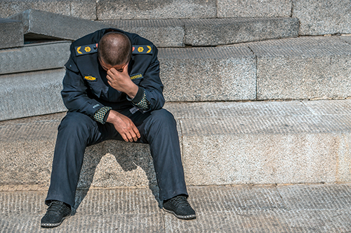 image of police officer looking distressed