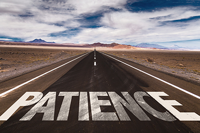 image of the word patience on a long road