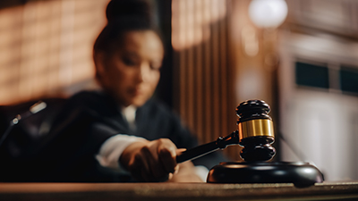 female judge using gavel in courtroom