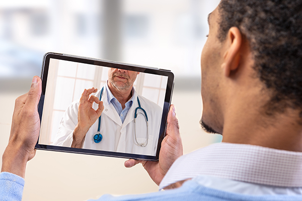 image of patient consulting with doctor on computer